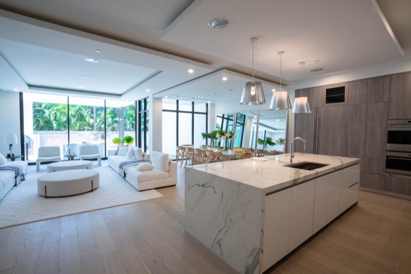 Open-concept custom kitchen with waterfall marble island, Fort Lauderdale FL