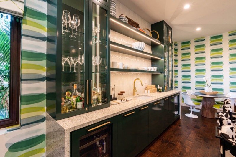 Custom wet bar with emerald tile and floating glass shelving, South Florida