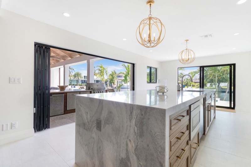 Custom kitchen island opening to the pool terrace, Fort Lauderdale FL