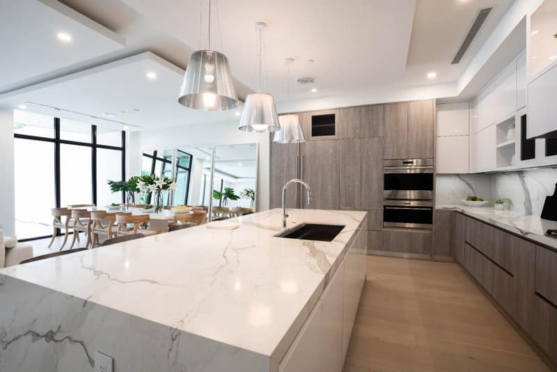 Custom kitchen with marble island and black-framed glass cabinets, Delray Beach FL